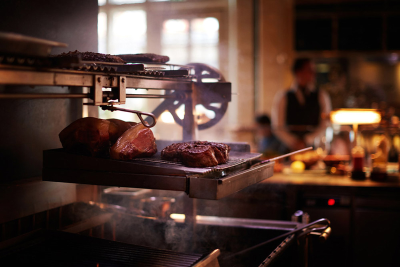 JOS-034-Steaks cooking on the grill in the chiltern firehouse.jpg