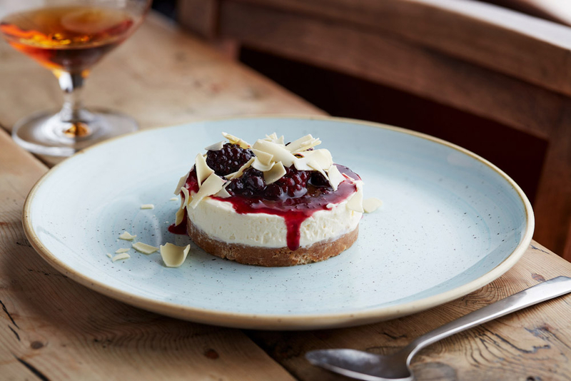 White chocolate Cheesecake with Berry compote and shards of chocolate.jpg