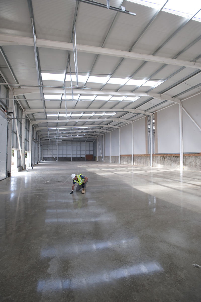 Foreman checking newly laid concrete polished floor