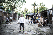 A boy poses with his football in Akokan, Cuba's poorest village